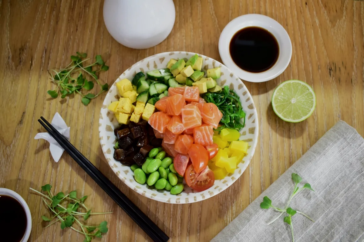 An overhead spread of cold dishes with small bowls and lime