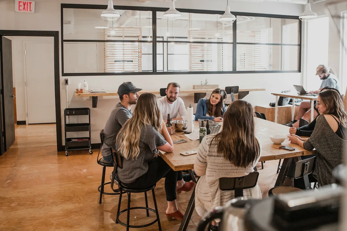 A communal table with people seated and eating