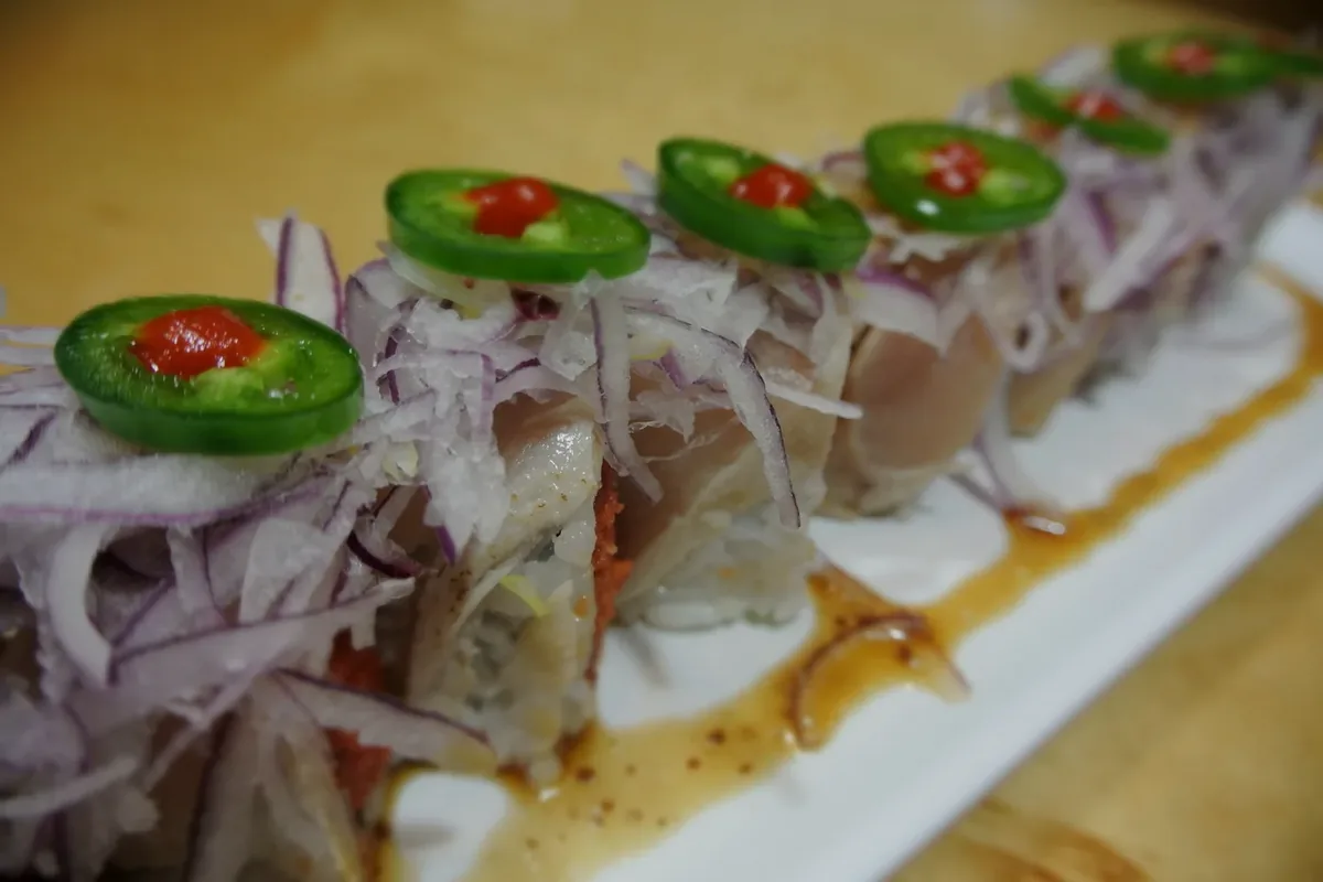Aloha roll with albacore, jalapeno and red onion over a spicy tuna roll