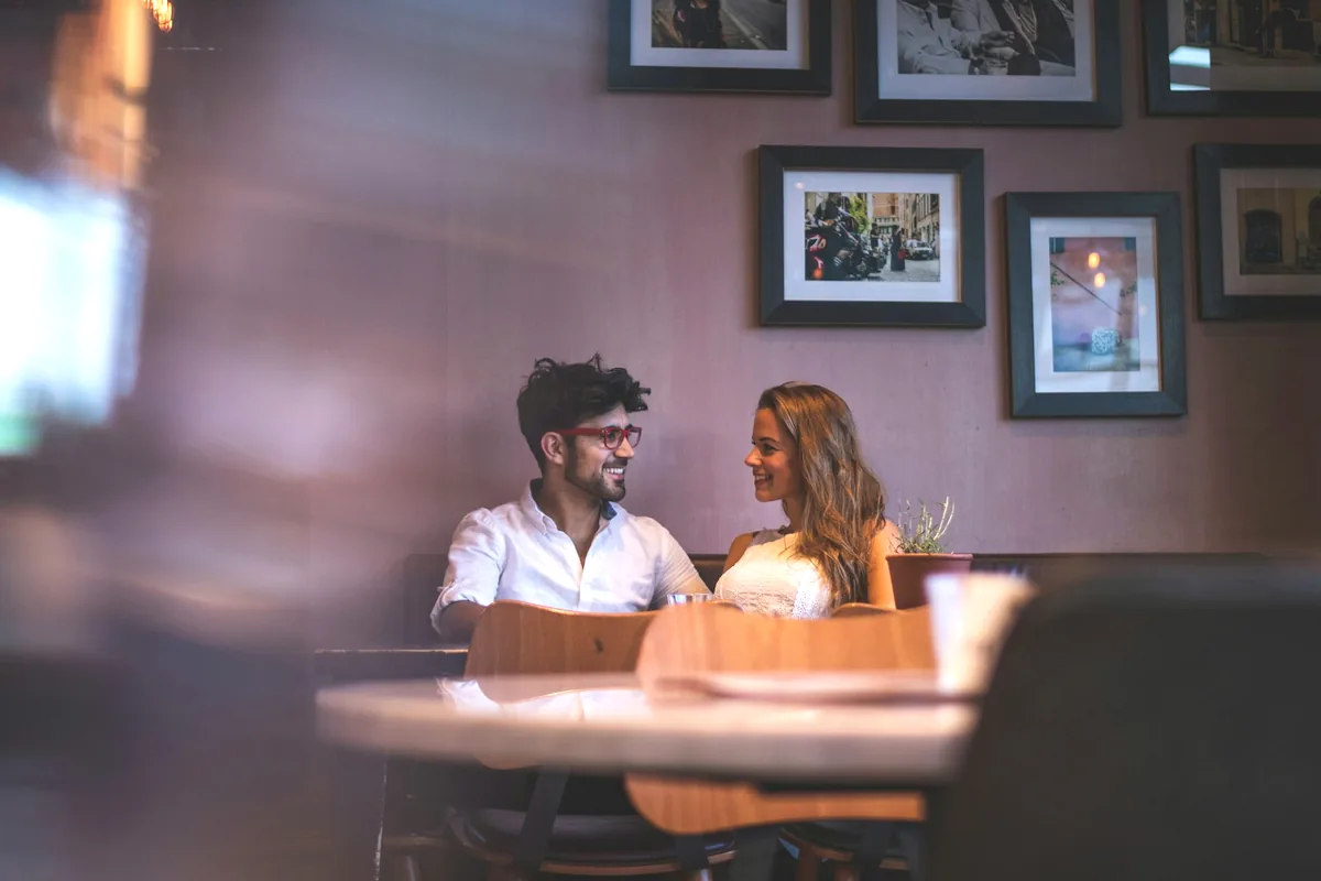 Two people seated across from each other in a restaurant booth