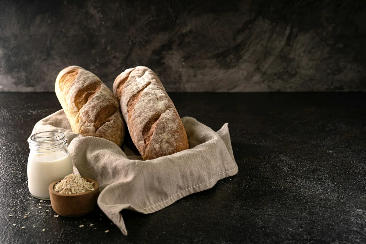 Several bread rolls in a cloth-lined basket