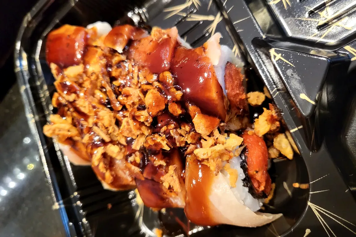 Crazy Albacore with spicy tuna inside, seared albacore and avocado on top with crunch onion