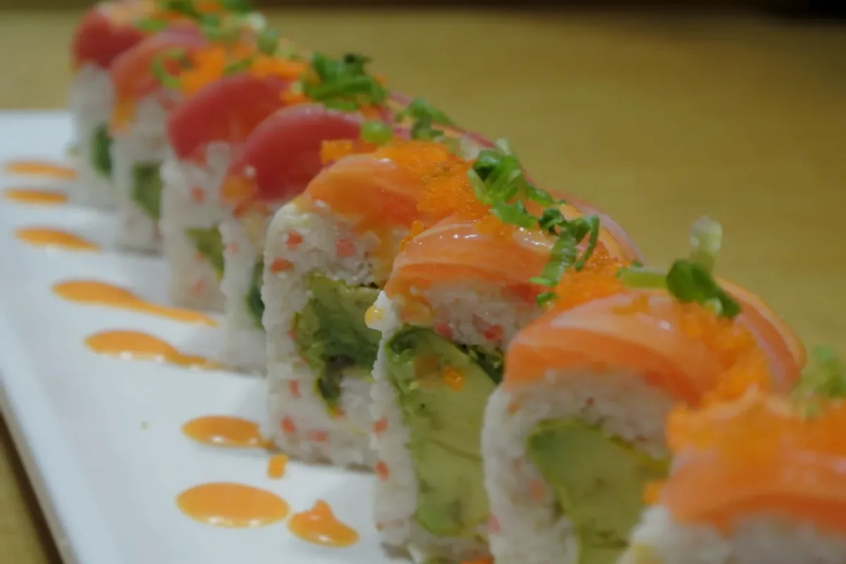 Crazy roll with avocado and crab, topped with salmon and tuna, served without rice