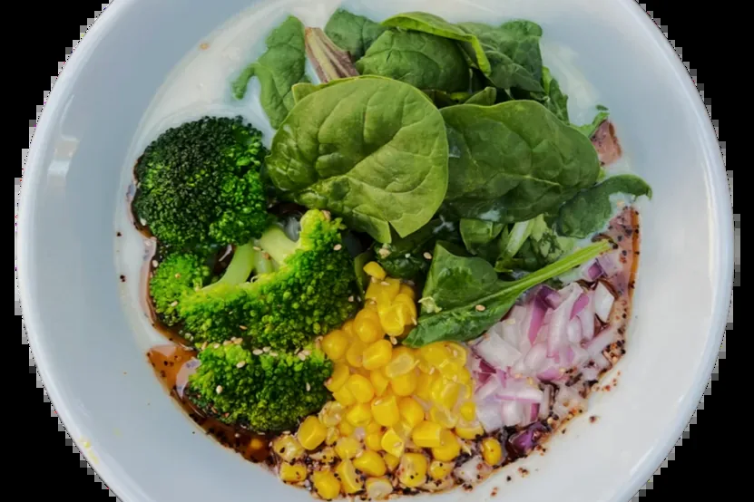 Creamy Vegan Ramen with broccoli, corn, red onion and spring mix on a vegetable broth