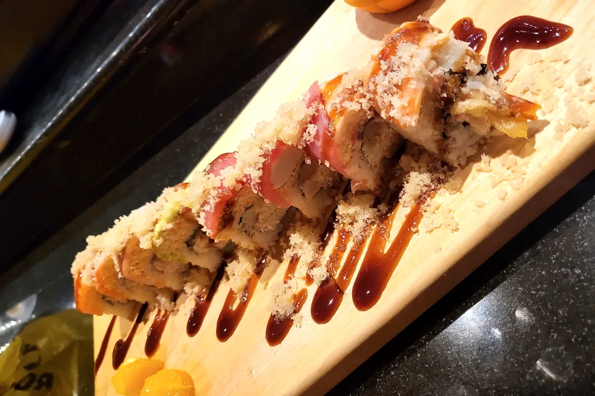 Crunch Rainbow roll topped with overlapping slices of assorted fish