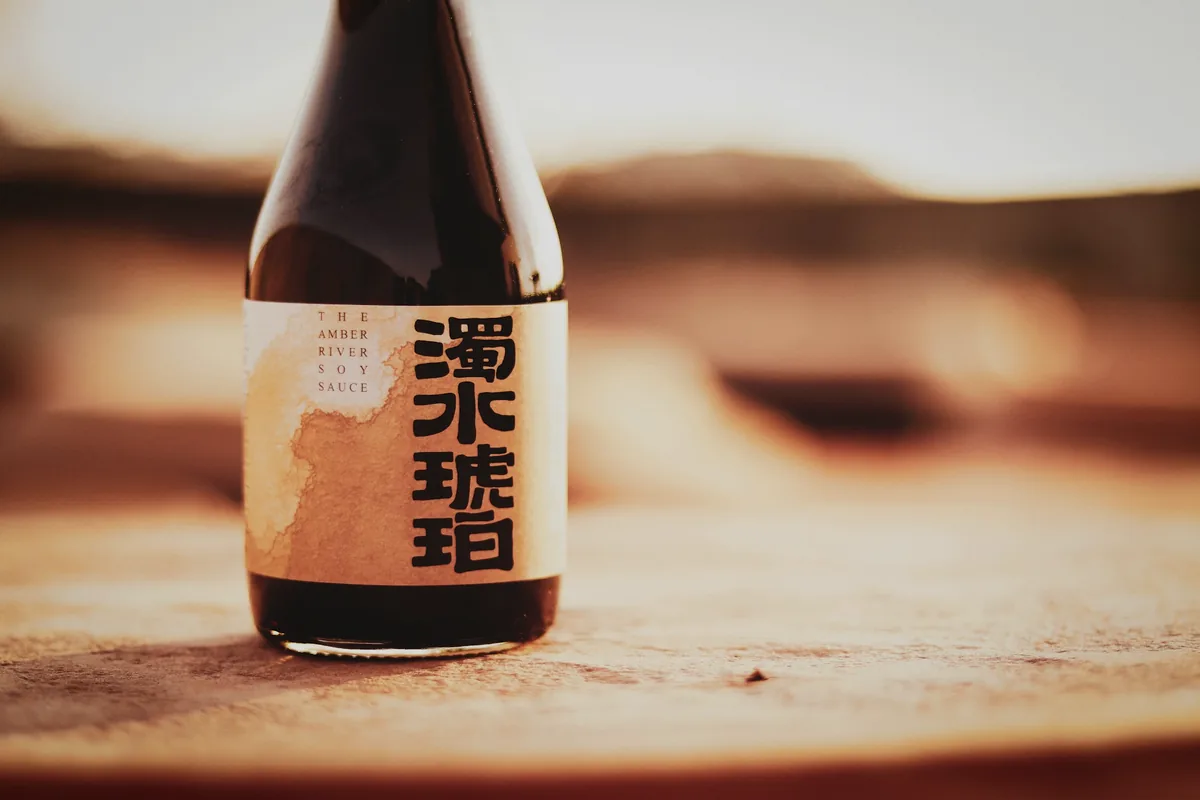 A single dark bottle photographed against a warm background