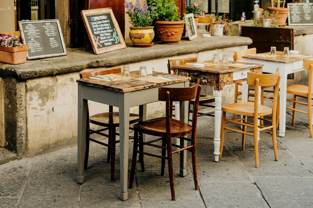 A restaurant counter and stools in daylight