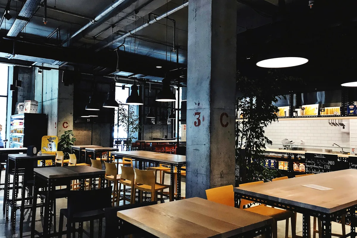 Set restaurant tables in a bright room during the day