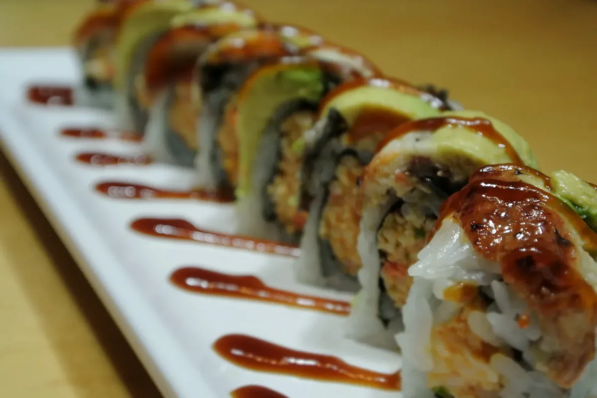 Eel Special, eel and avocado over a spicy crab roll, glazed with a dark sauce