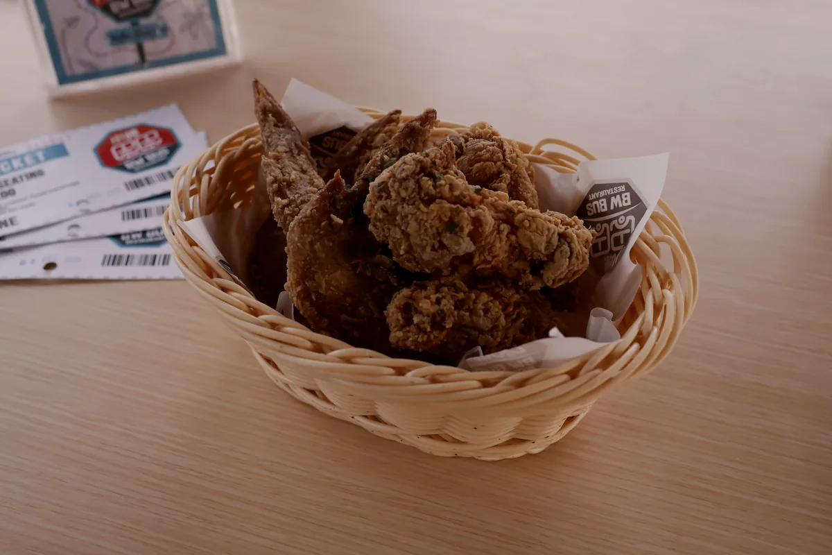Fried chicken pieces served in a paper-lined basket