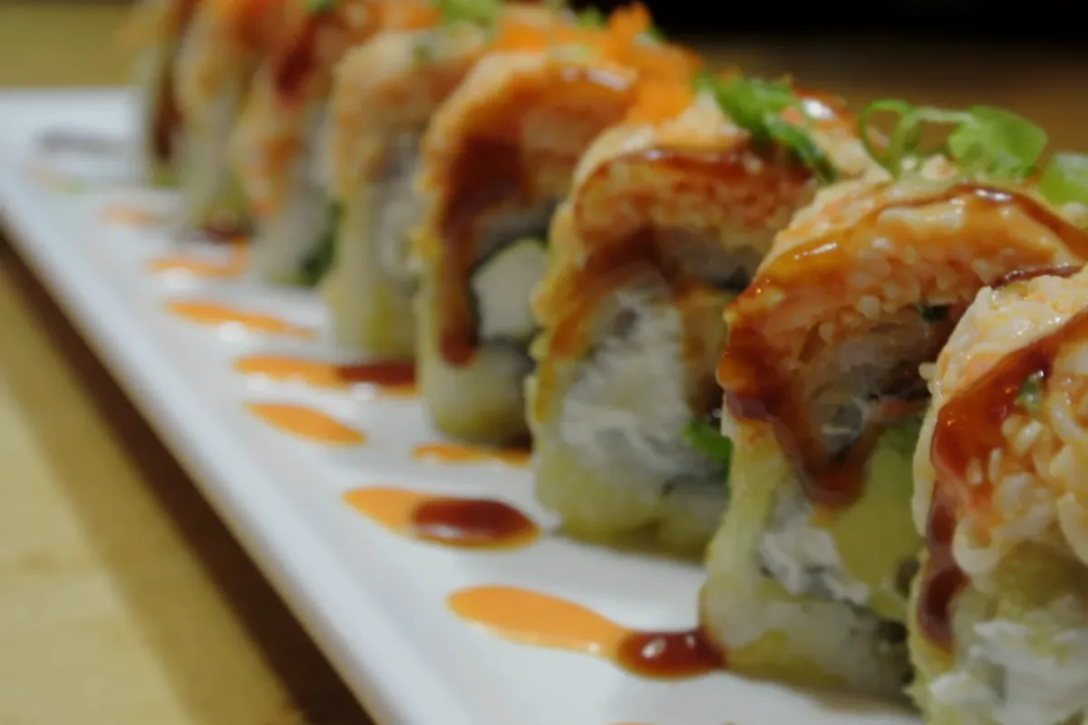 Golden Tiger roll with spicy crab over deep fried shrimp tempura and cream cheese