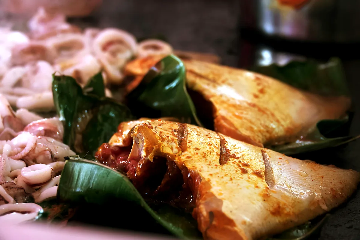 Whole squid cooking over a grill