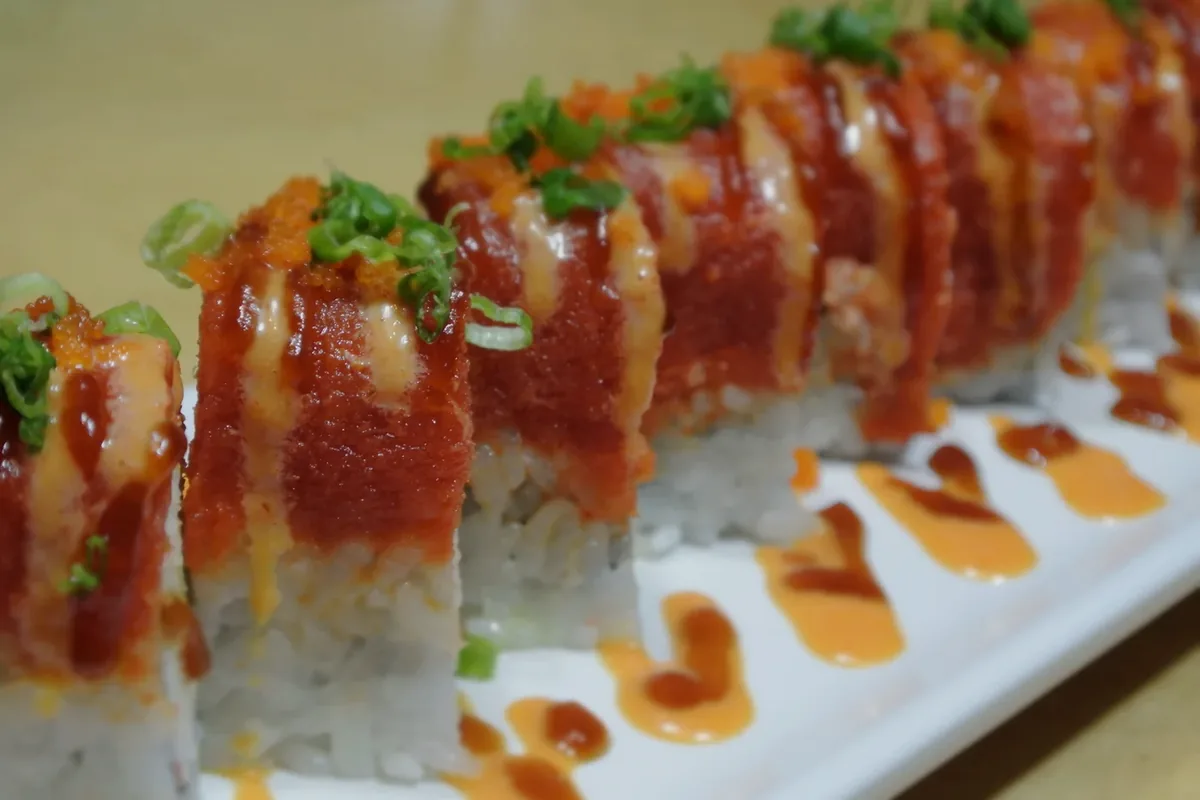 Hot Night roll, spicy tuna over a shrimp tempura roll, sliced into eight pieces