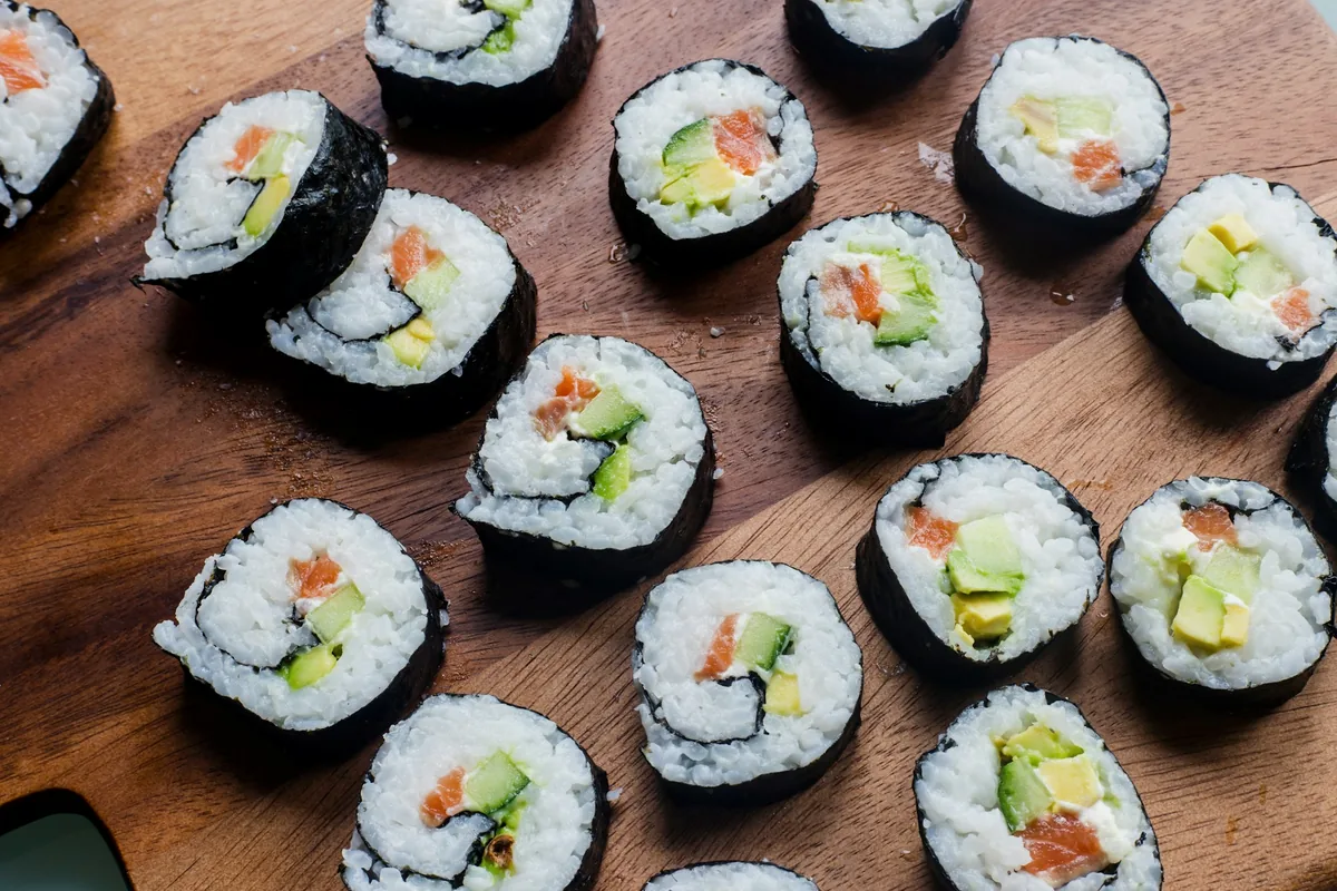 Rows of cut maki rolls photographed from directly overhead