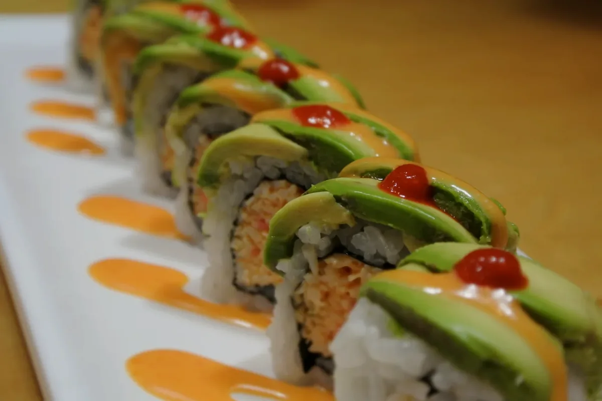 New Mexican, avocado over a spicy crab roll with jalapeno on top