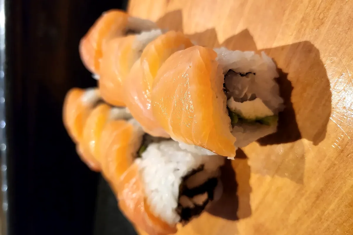New Philly, cream cheese and avocado with salmon laid over the top