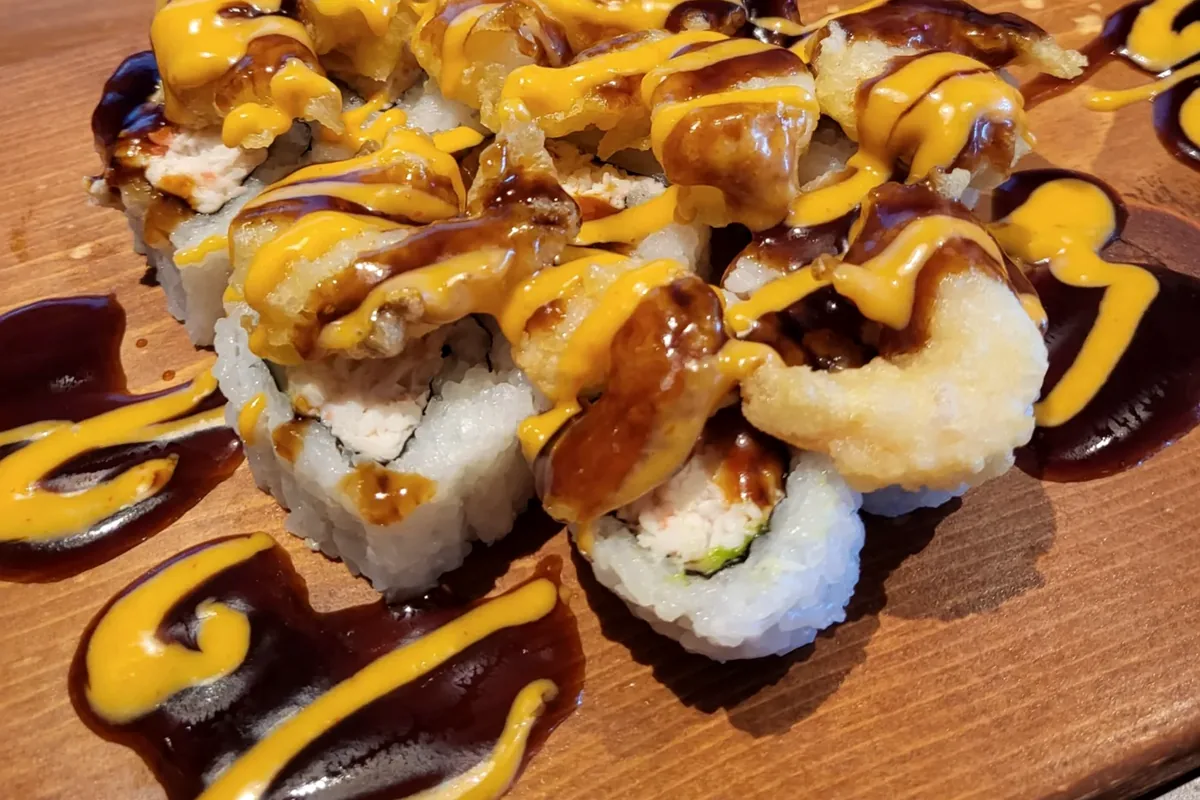 Popcorn Shrimp roll built on a California roll and finished with sauce
