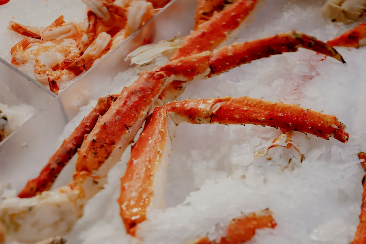 Whole crab legs displayed on crushed ice