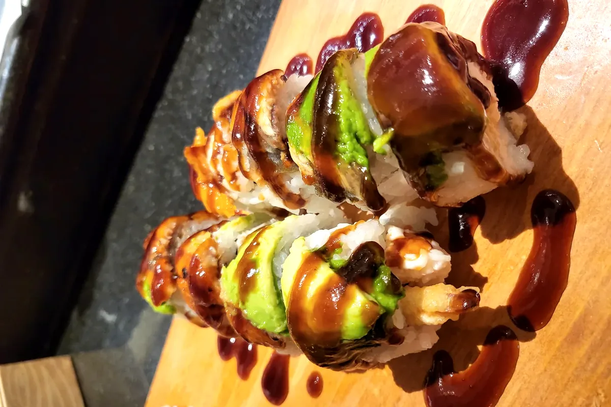 Red Bull roll with shrimp tempura and crab, topped with eel and avocado