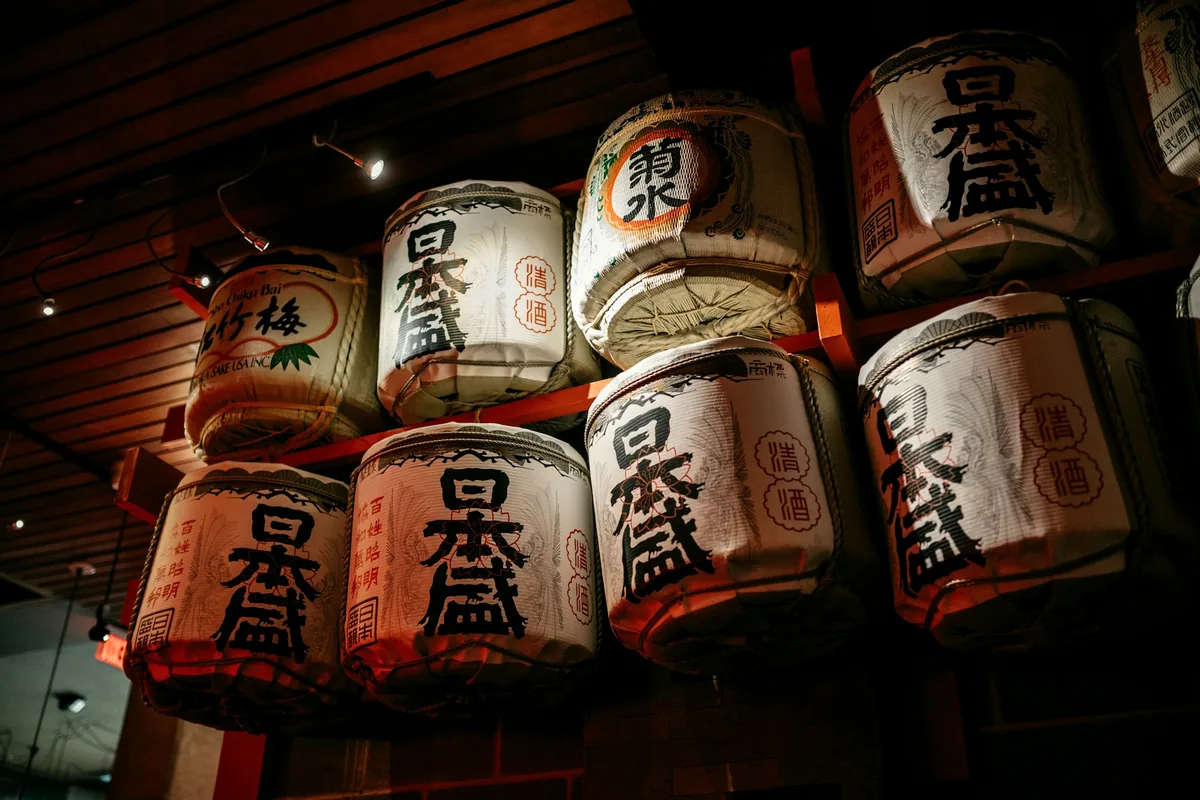 A stacked wall of decorated ceremonial sake barrels