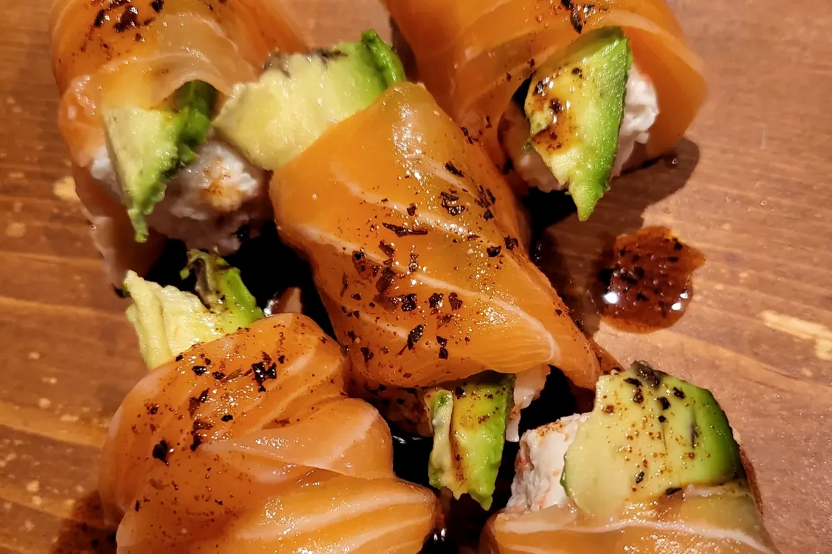 Salmon Lover, crabmeat and avocado wrapped in salmon and served without rice