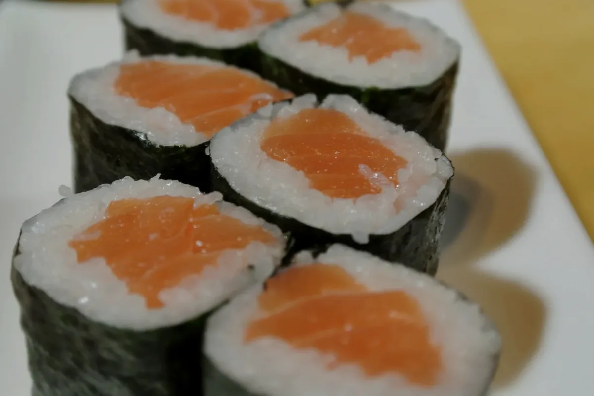 Salmon Roll cut into six pieces and wrapped in nori
