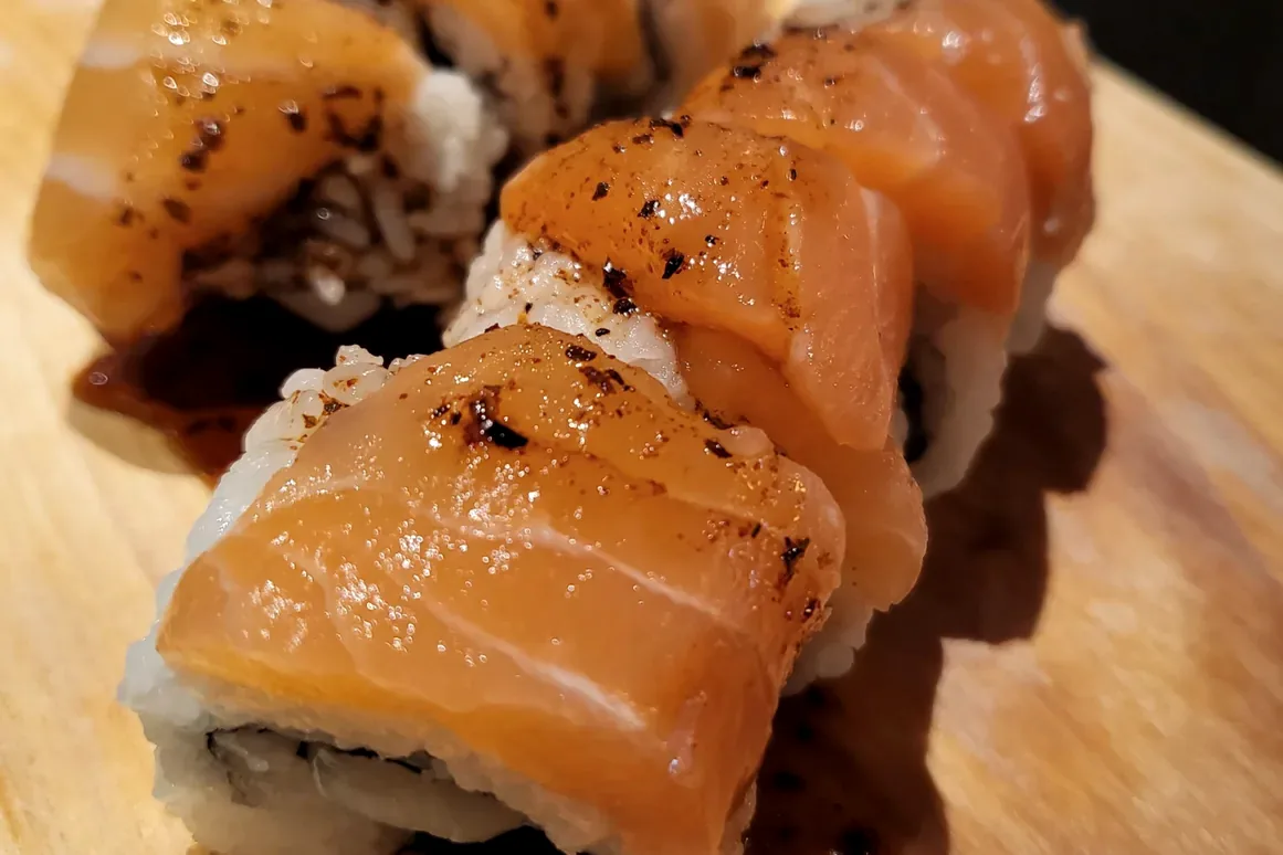 Salmon Scallop, salmon draped over rice and finished with sauce