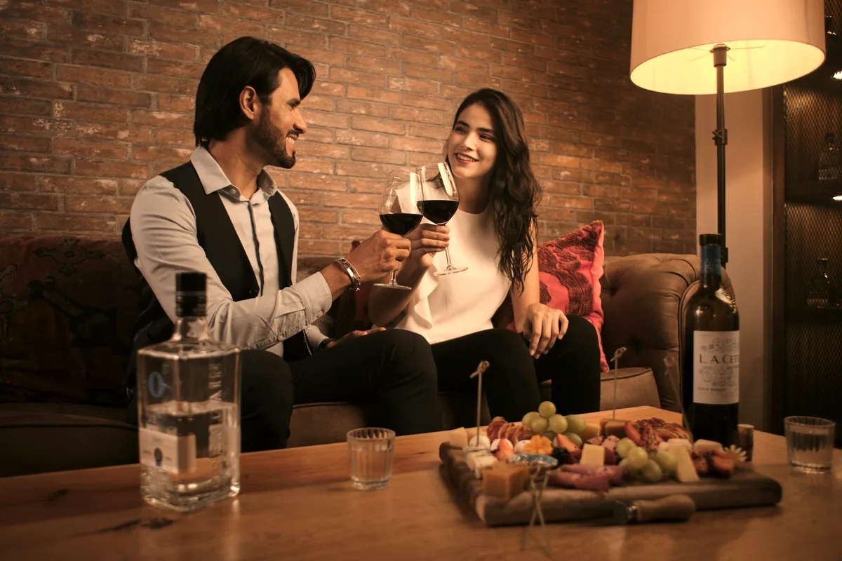 Two people at a restaurant table sharing a board of food