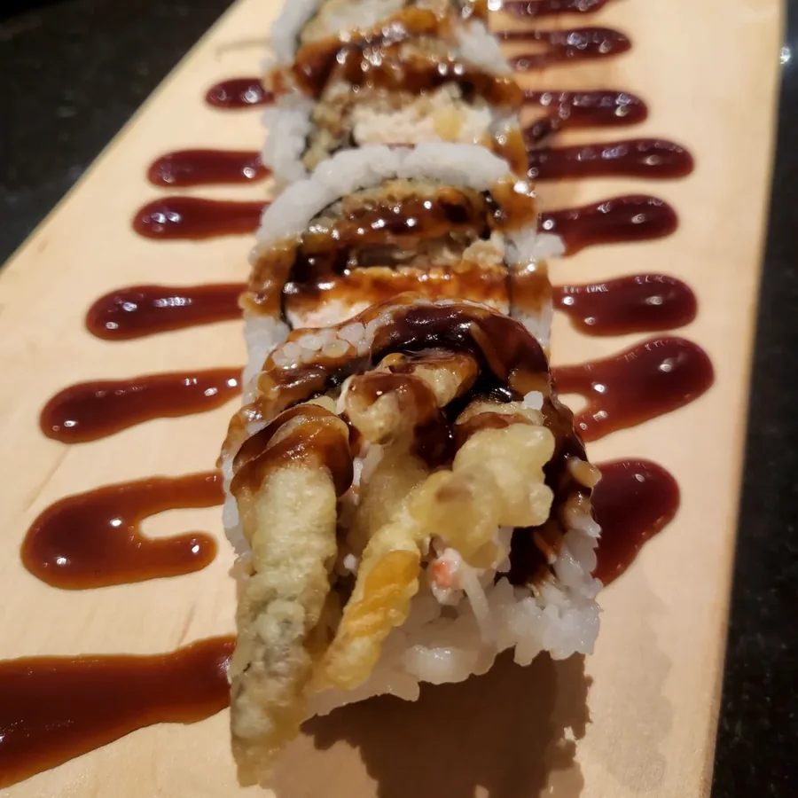 Spider roll with soft shell crab and eel sauce on a maple board