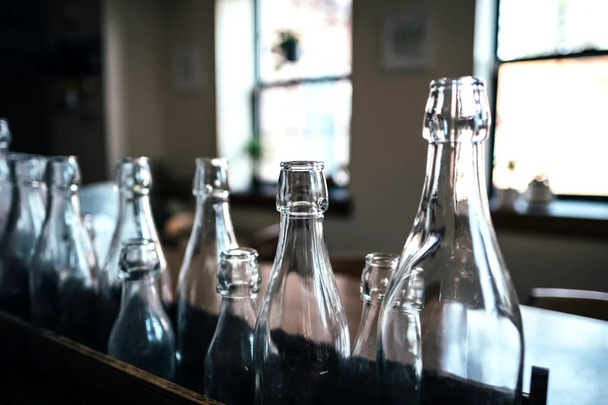 Glass bottles lined up along a restaurant counter