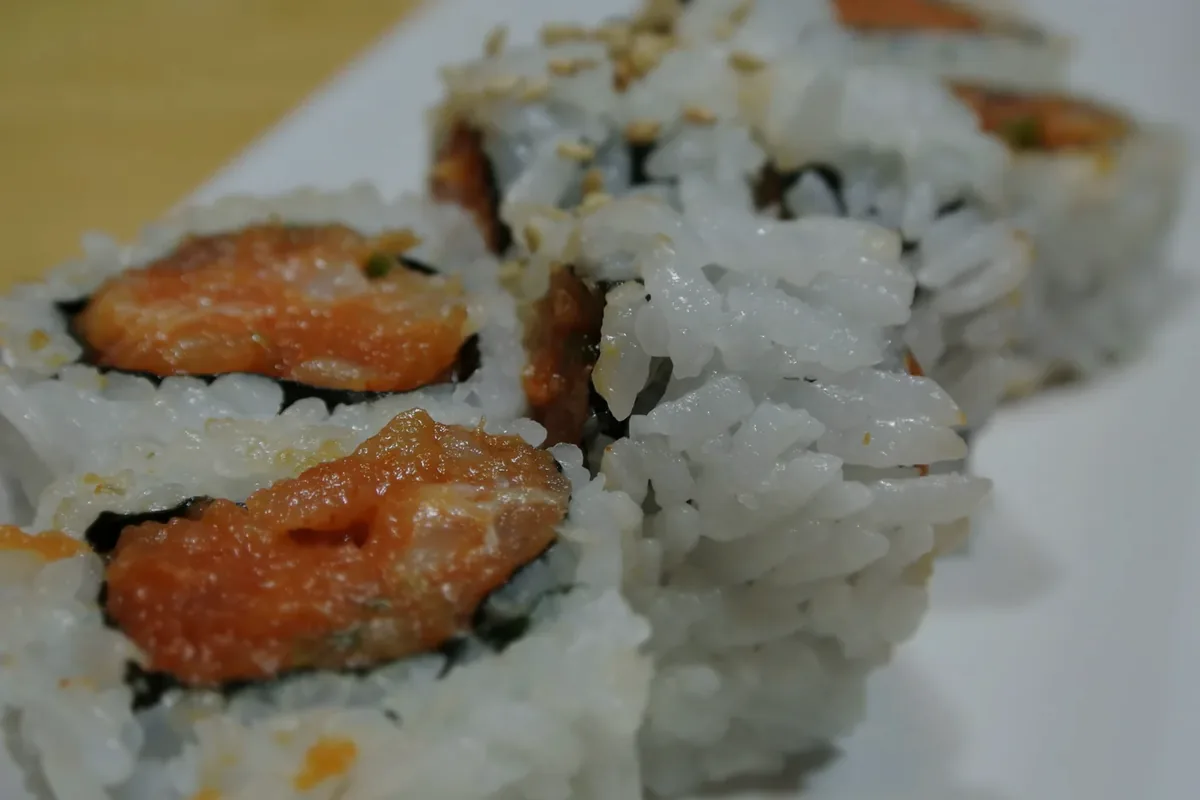 Spicy Albacore Roll cut into pieces on a white plate
