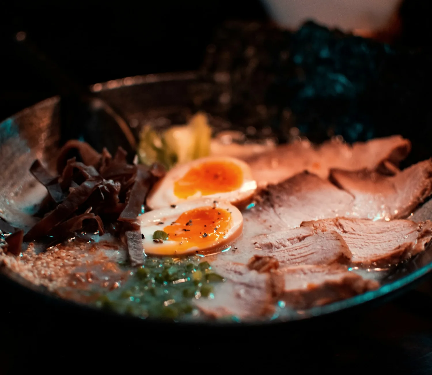 Tonkotsu ramen with sliced chashu pork, halved marinated eggs and kikurage mushrooms