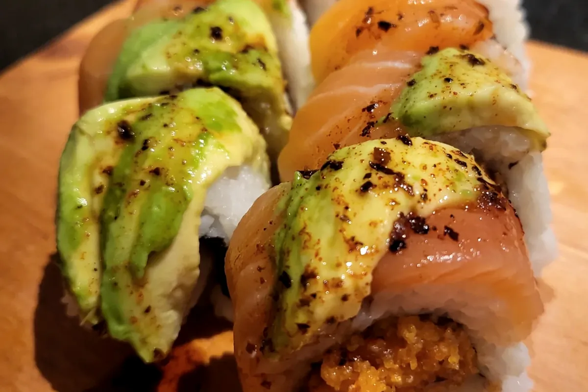 Sunkist, spicy tuna and avocado topped with salmon and drizzled with sauce