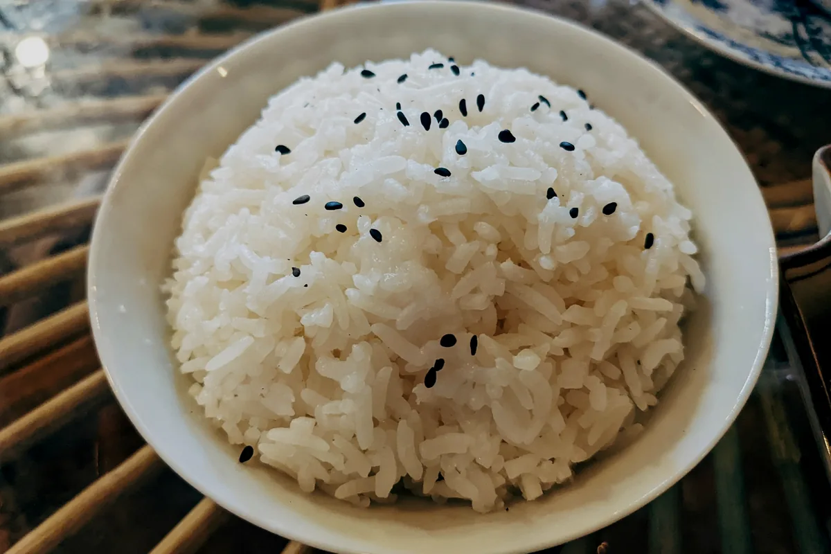 A bowl of short grain sushi rice seasoned with vinegar and sprinkled with sesame