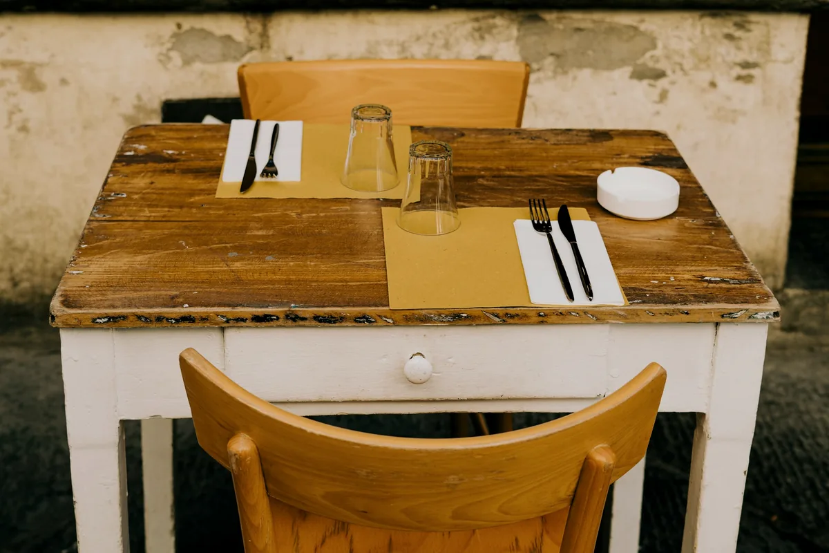 A small restaurant table laid for two people