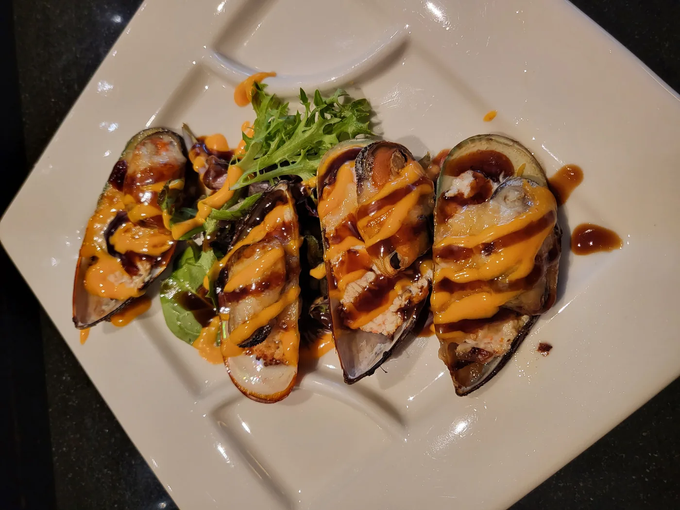 Baked Green Mussel - four mussels on the half shell with eel sauce and spicy mayo