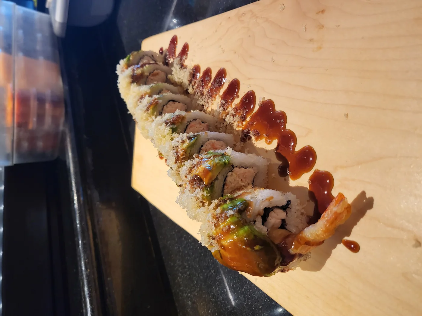 Crunch Caterpillar roll - shrimp tempura and crab with avocado laid over the top