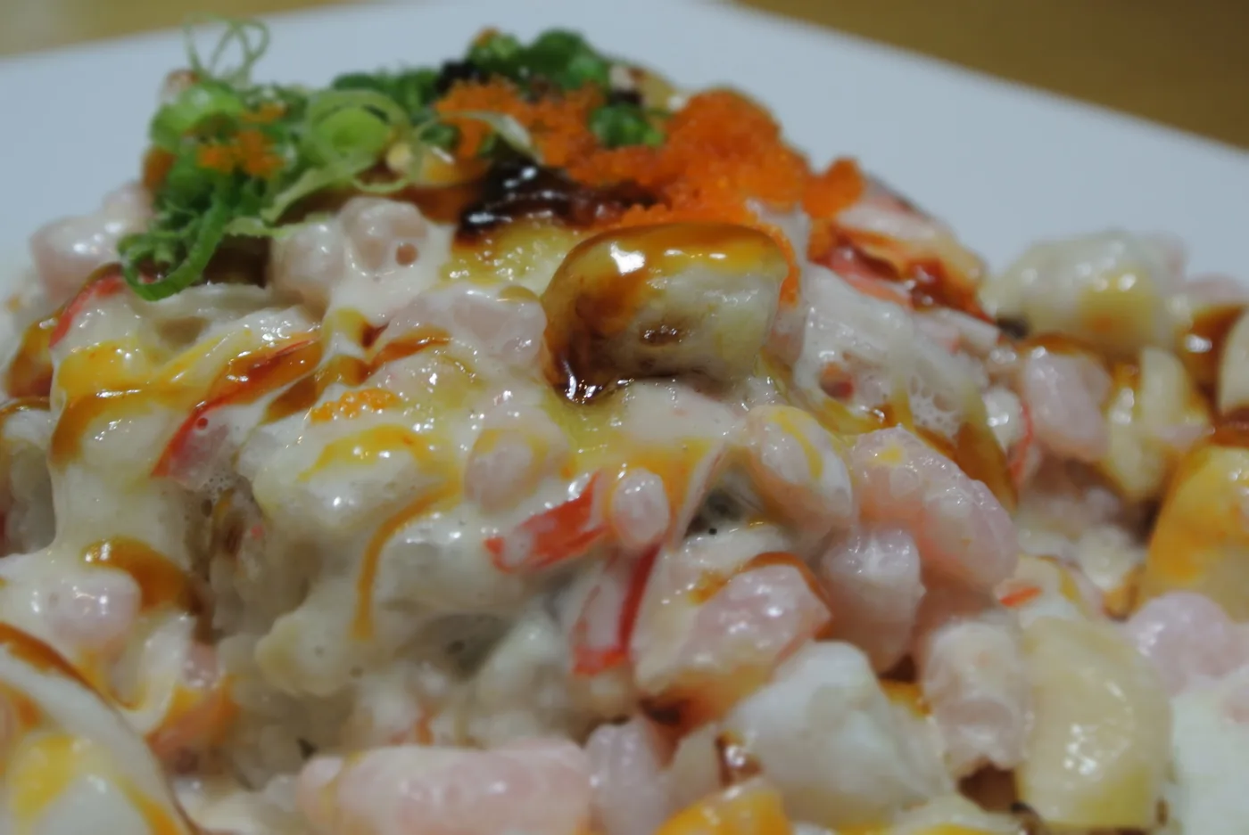 Dynamite roll - baked seafood and kanikama over a California roll