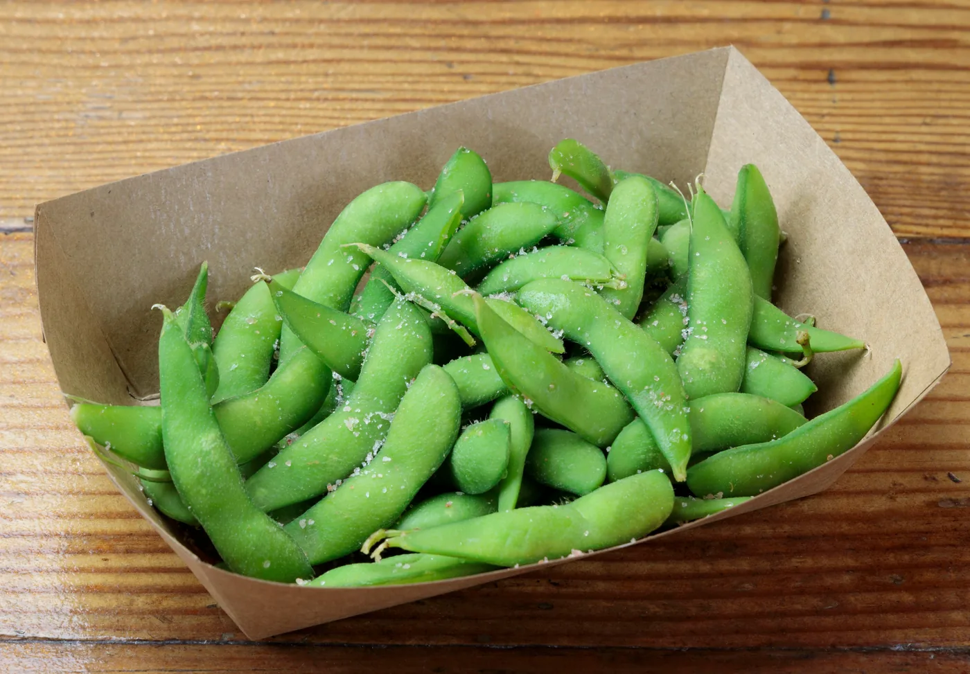 Edamame pods in a paper tray