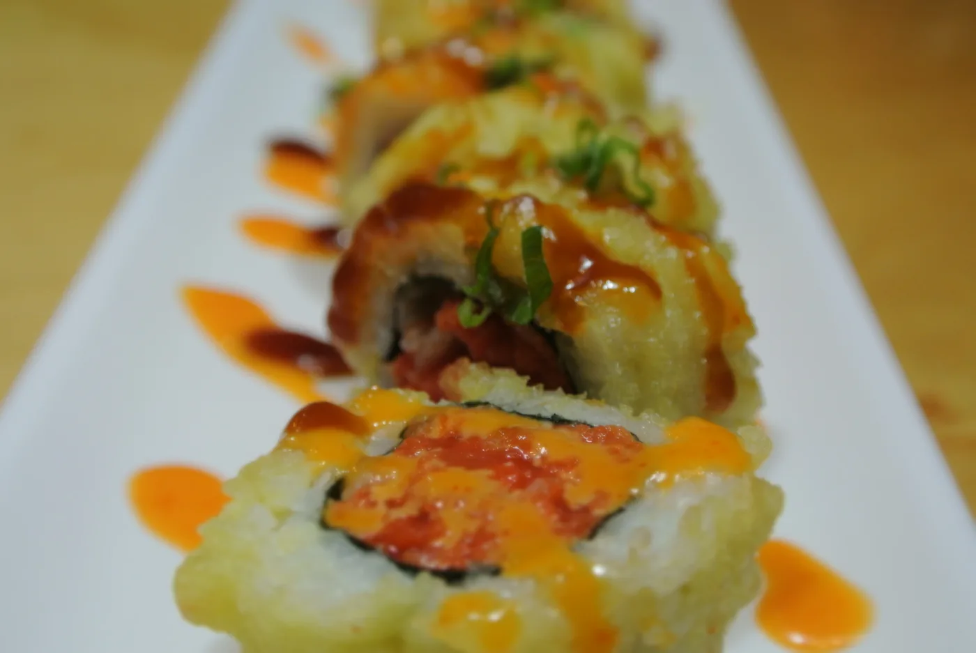 Golden Spicy Tuna - a deep fried spicy tuna roll with sauce