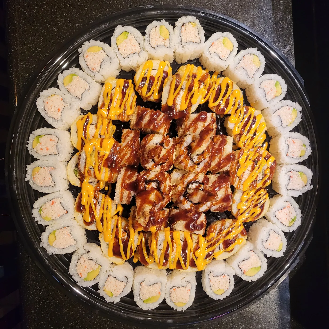 A 64-piece Kid's Land platter ringed with cut rolls around a sauced centre