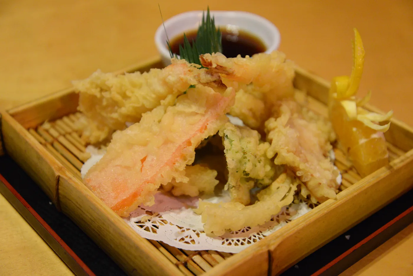 Mixed Tempura of shrimp and vegetables in a bamboo basket with dipping sauce