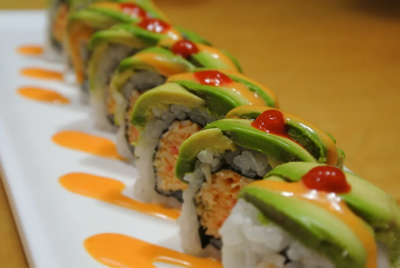 New Mexican roll - avocado over a spicy crab roll with jalapeno on top