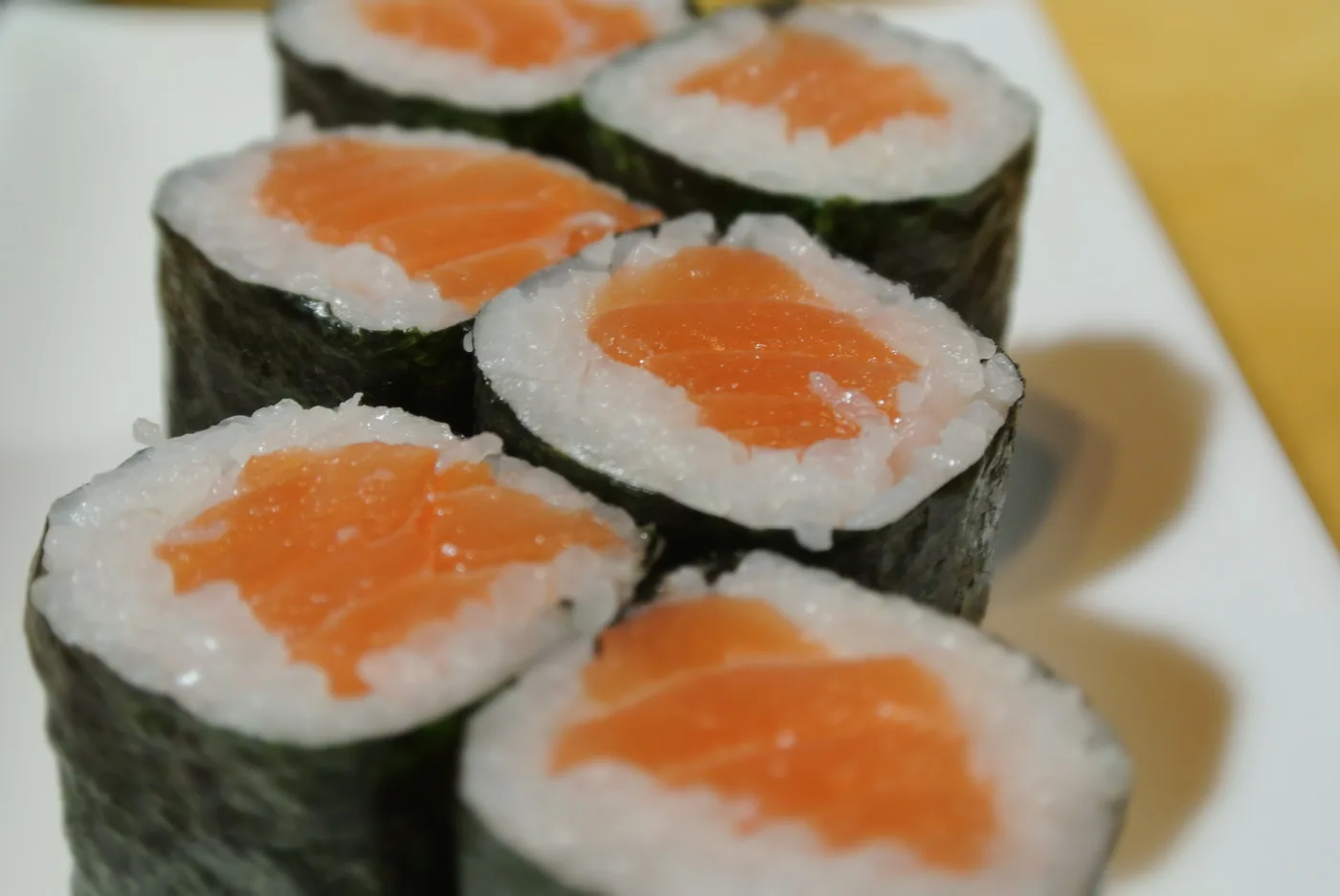Salmon Roll cut into pieces with salmon visible in the centre
