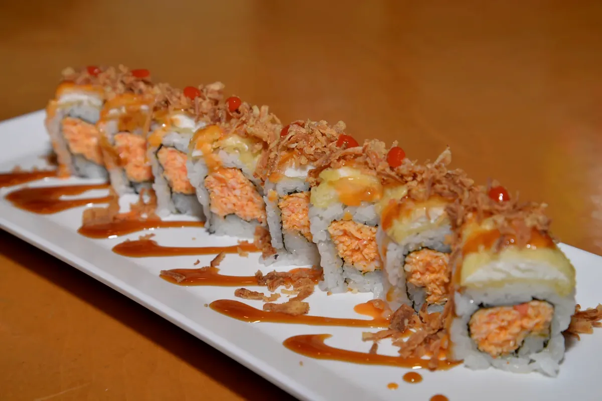 The Tokyo roll, tilapia tempura and crispy onion over a spicy crab roll