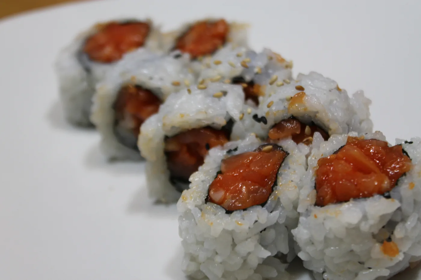 Spicy Salmon Roll with sesame seeds on the rice