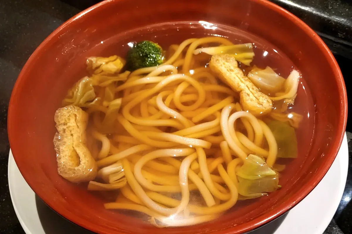 Plain Udon in clear broth with fried tofu and fish cake